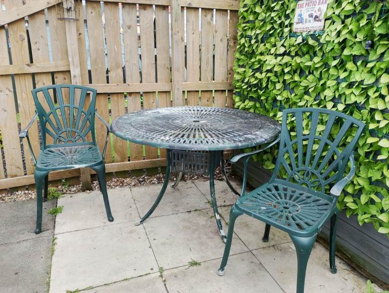 Cast iron Table and 2 chairs 