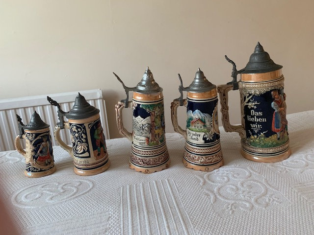  FIVE GERMAN STEIN TANKARDS, two with musical key underneath