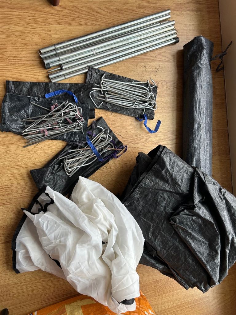 Half a camping tent. Poles, pegs, and tarp 
