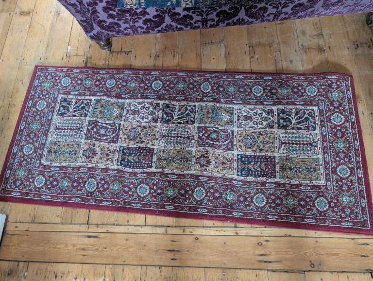 Rug with traditional design motif mostly burgundy