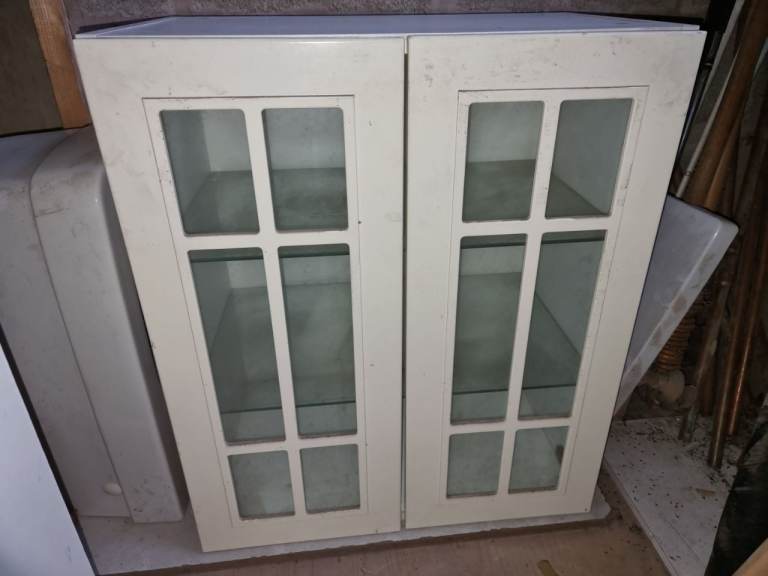 White cupboards with glass doors and shelves
