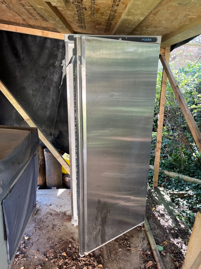 Larder fridge with wire rack shelving