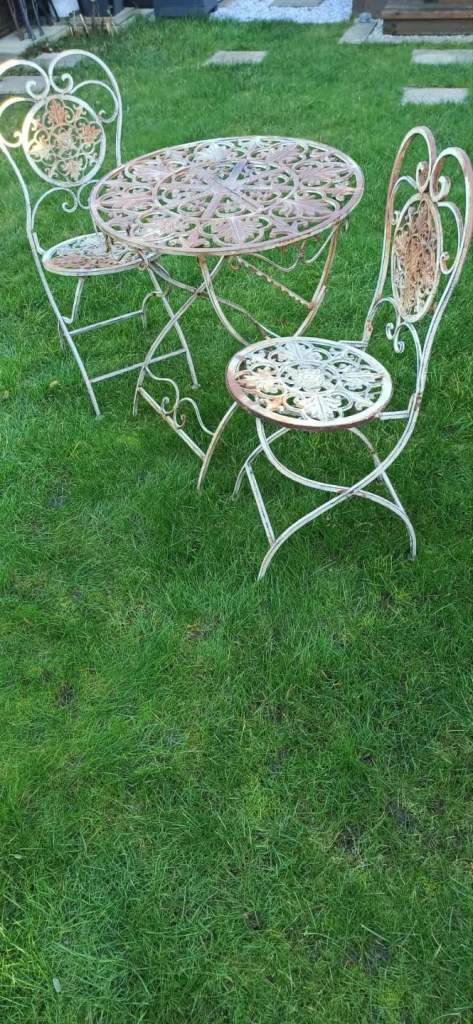 Wrought iron garden furniture set, vintage bistro set with a table and two chairs. 