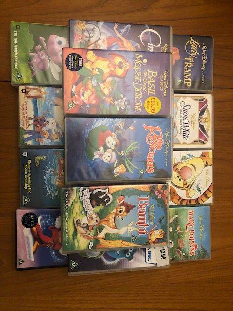 Collection of Disney VHS tapes and player