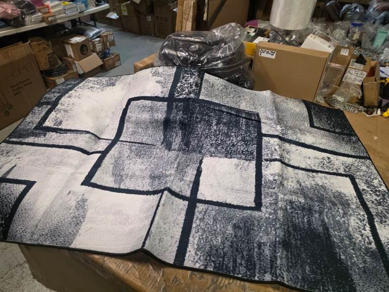 A new dark blue,grey,white patterned rug. 