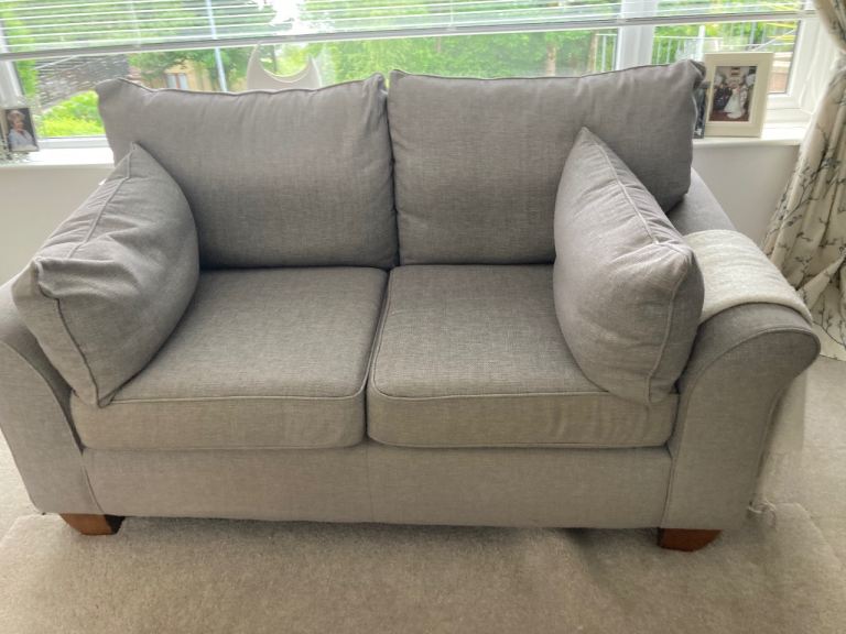 3 seater light grey sofa and 2 seater darker grey plus grey pouffe. All in good condition.