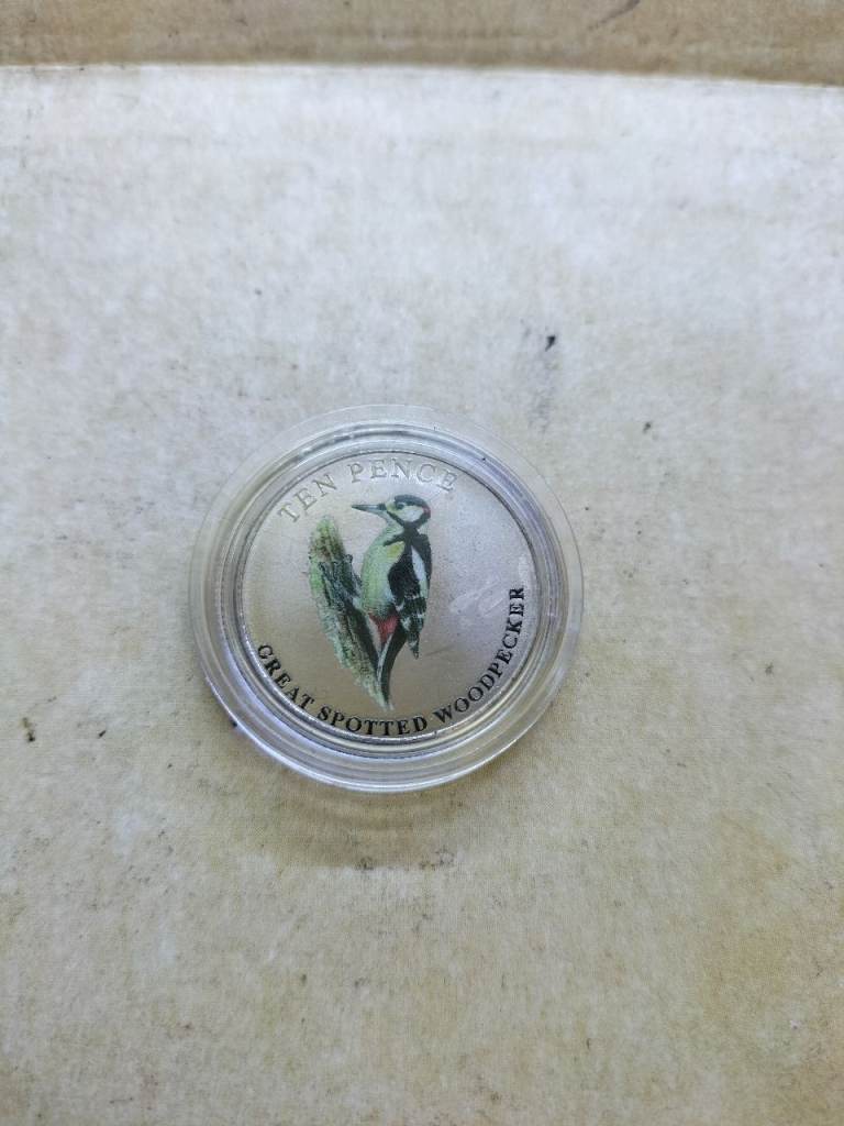2021 Guernsey Ten Pence coin featuring a colorized image of a Great Spotted Woodpecker 