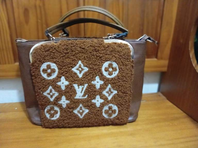 pre-owned Louis Vuitton OnTheGo GM Monogram Brown Teddy tote bag. 