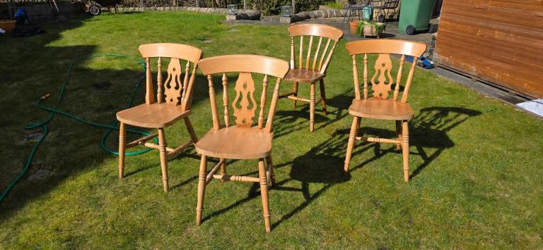 Four wooden beach chairs 