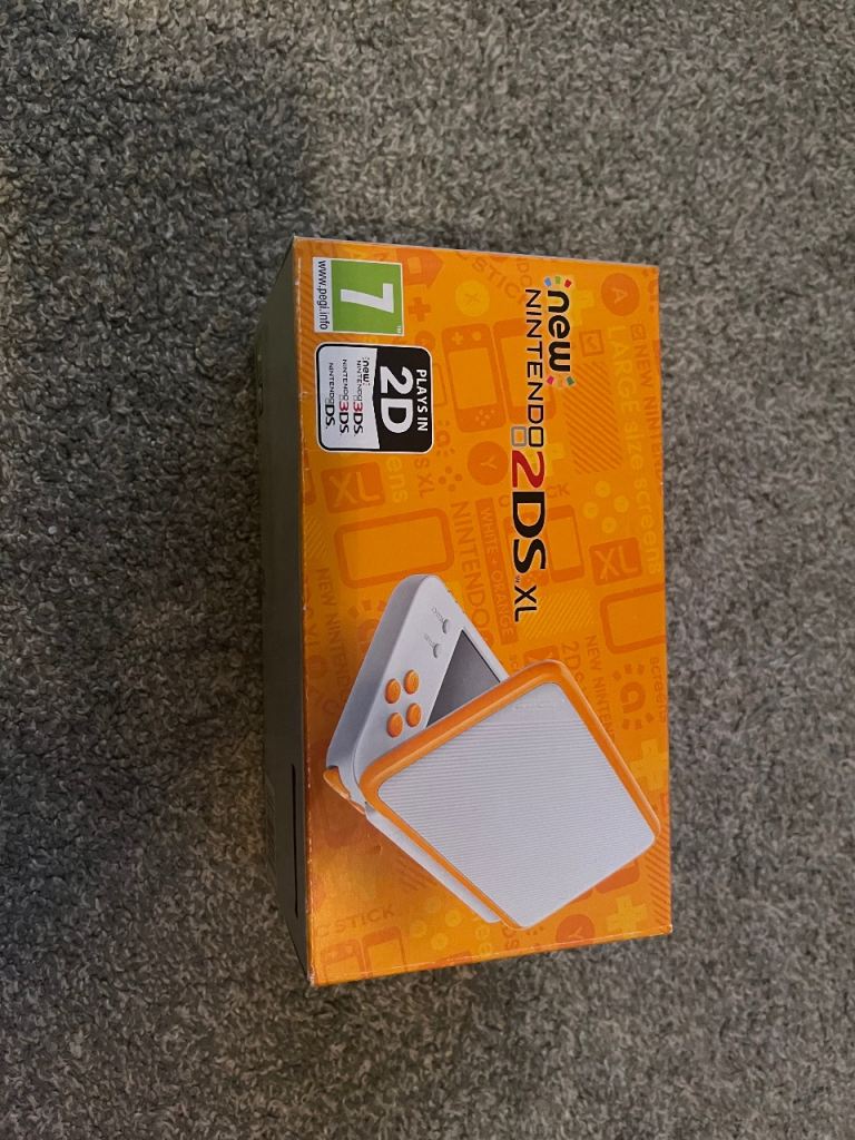 Nintendo 2ds XL white and orange console with 3 Pokémon games
