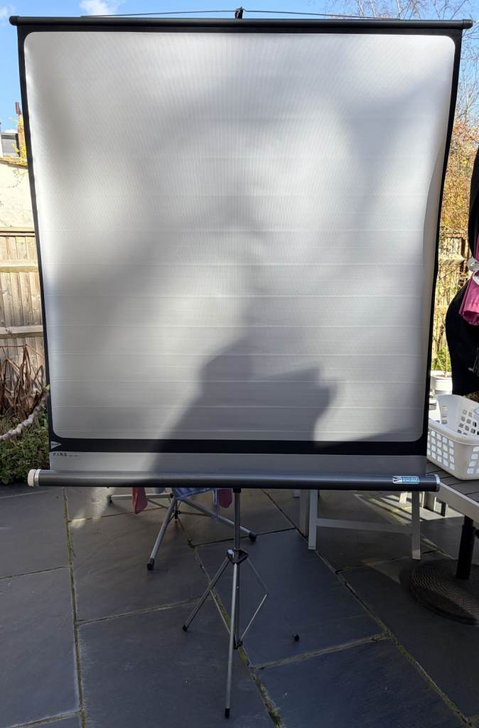 Vintage silvered projector screen with stand. By Fins from Boots