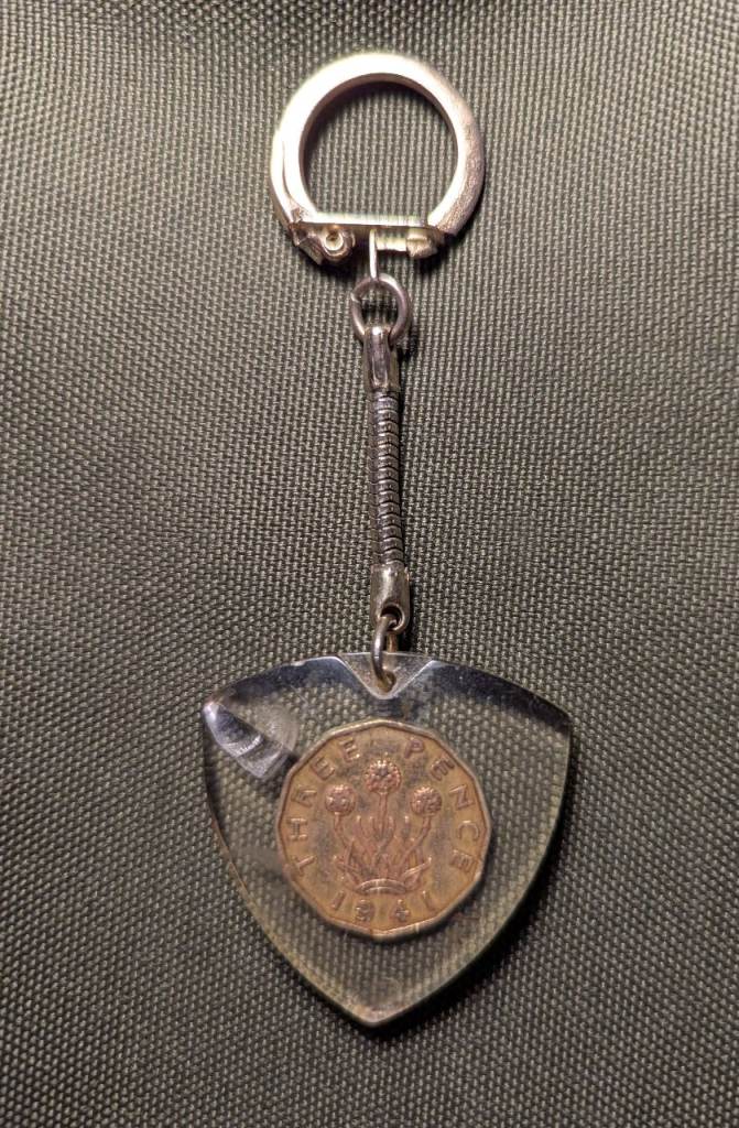 Vintage British keychain featuring a 1941 nickel-brass threepence coin – acrylic casing is chipped 