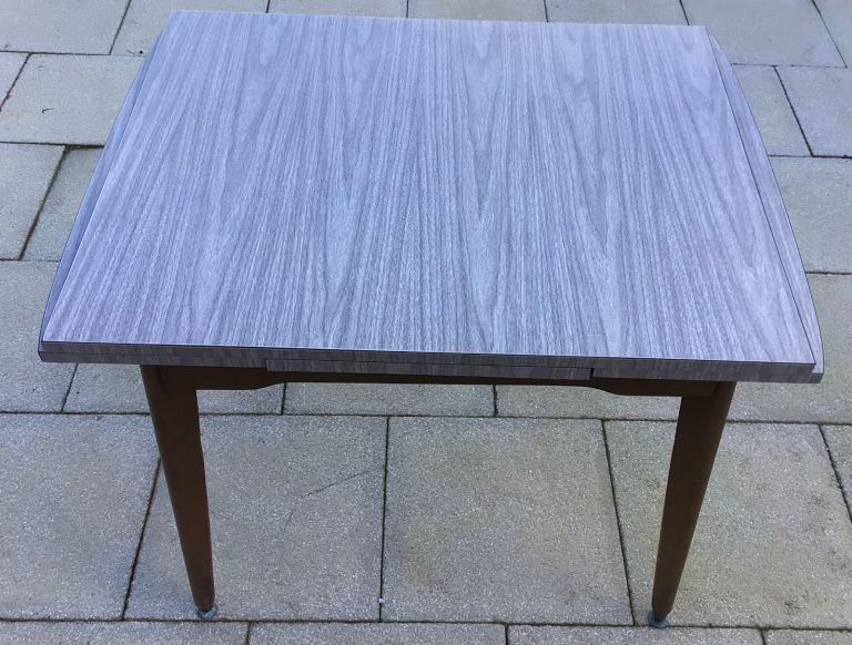 An original vintage 1960’s extendable grey pattered Formica dining table