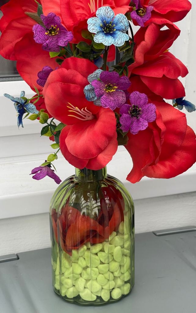 Lovely Multicoloured Artificial Flowers in Green Glass Vase