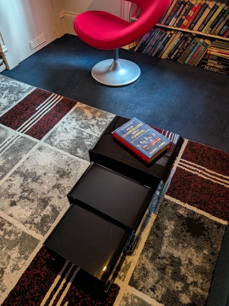 Nest of black glass coffee tables 