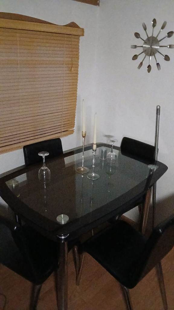 Dining table glass , silver tube legs and leather look chairs