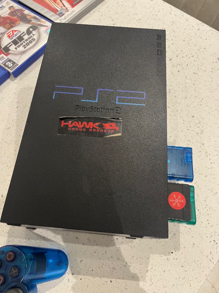 PlayStation 2 with games and microphones 