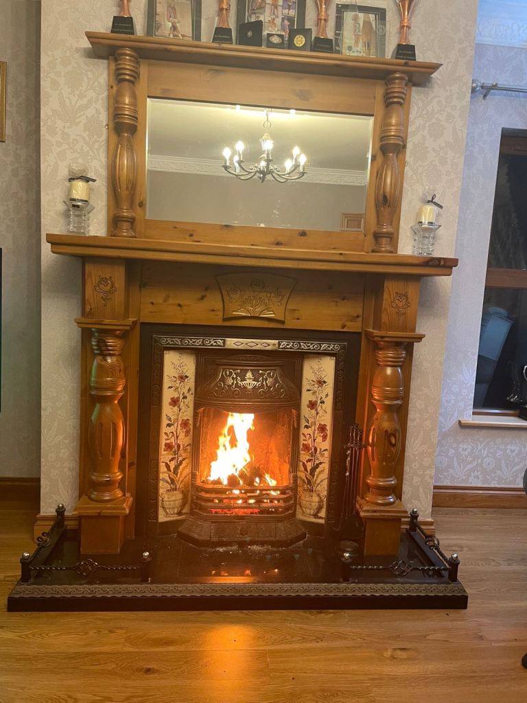 Fireplace with wooden surround and wooden mirror