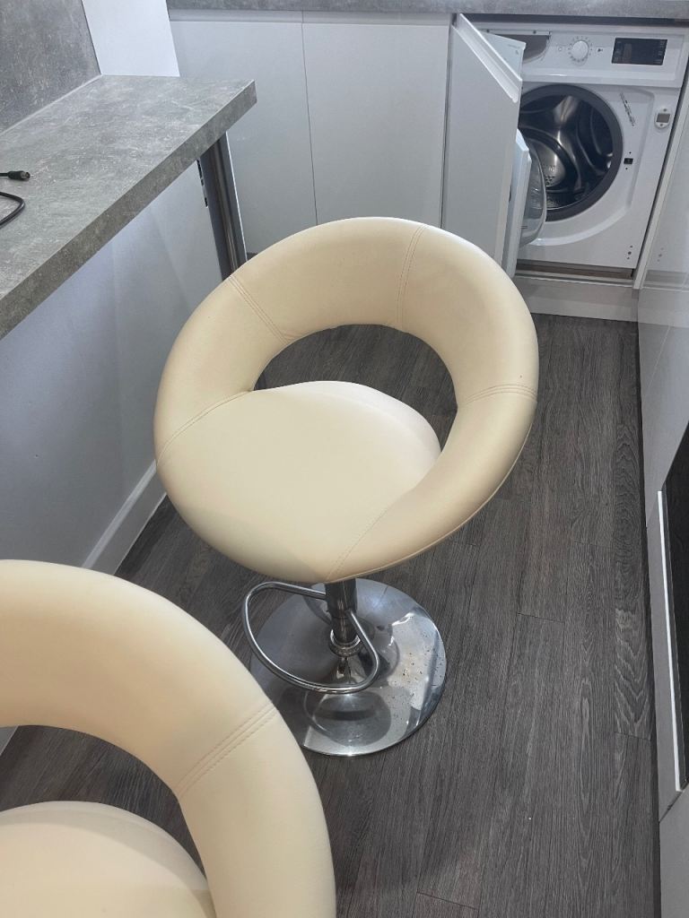 2 cream dining chairs.