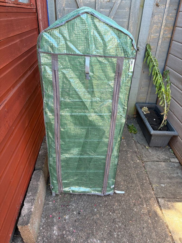 Compact Walk-In Greenhouse with Metal Shelving