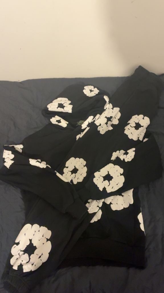 Denim Tears Cotton Wreath tracksuit – black hoodie + joggers with the white wreath print.