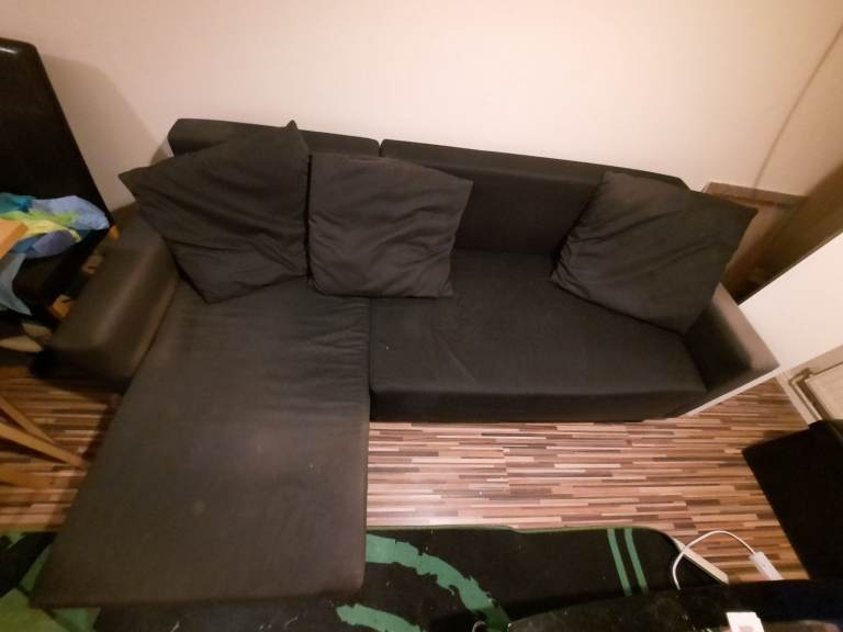 Ikea Lugnvik black sofa bed with chaise lounge and storage