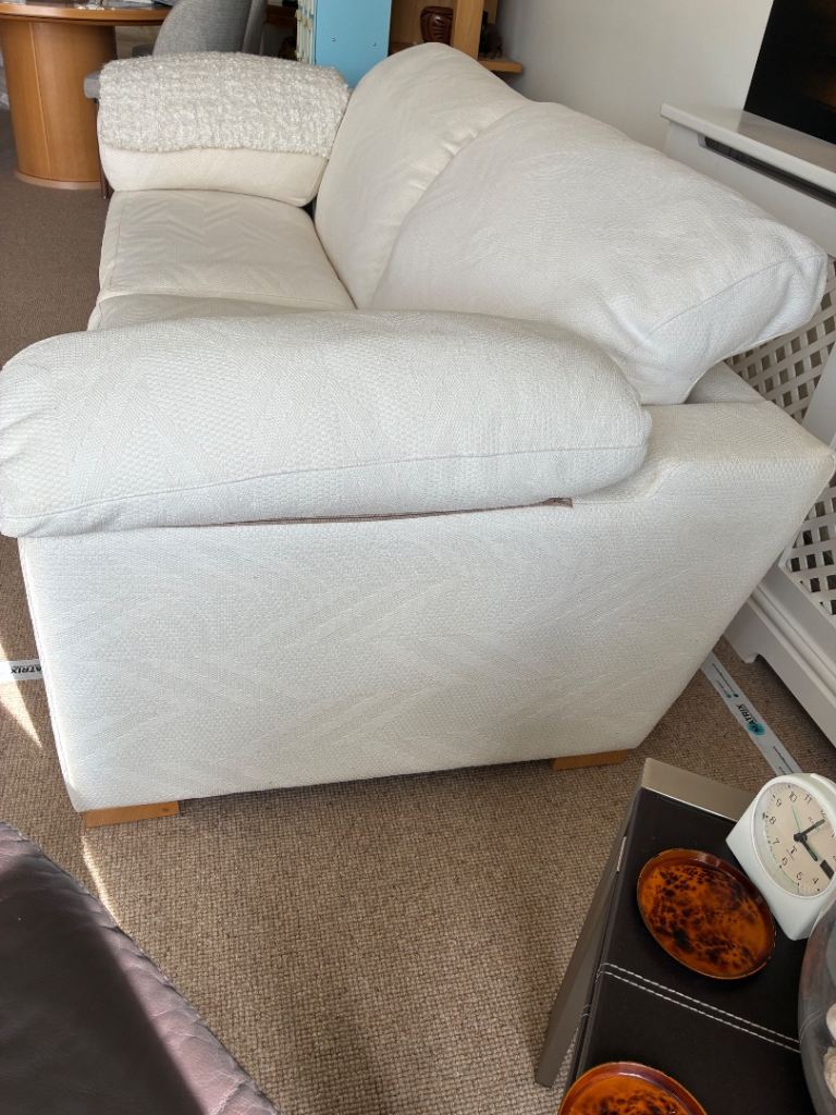 Two off white fabric two seater sofas