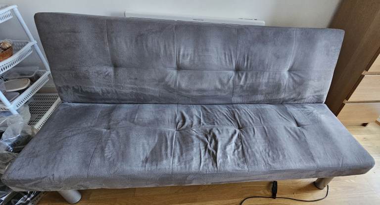 Grey coloured three seater convertible sofa bed for sale £50.  