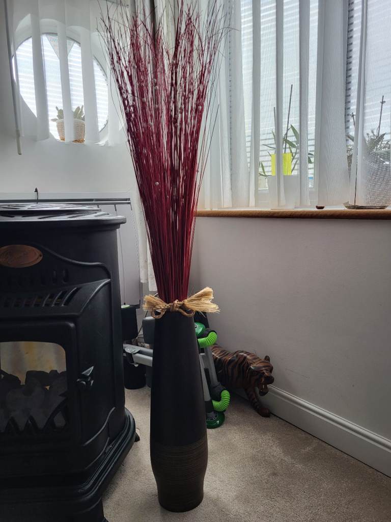 BEAUTIFUL WALNUT WOOD TALL VASE WITH RED GRASSES ARRANGEMENT.