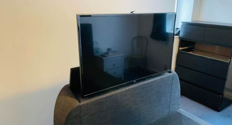Bed frame with folding tv mechanism