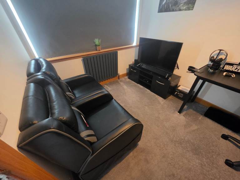 AORUS FV43U 4K UHD Gaming setup with Leather recliners and unit.