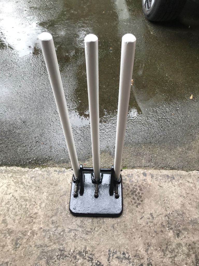 Vintage Spring Back Cricket Stumps on a Cast Iron Base, refurbished and in great working order.