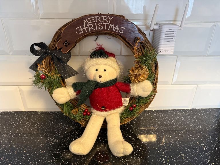Teddy Christmas wreath featuring a plush Teddy figure and a "Merry Christmas" sign 14" 