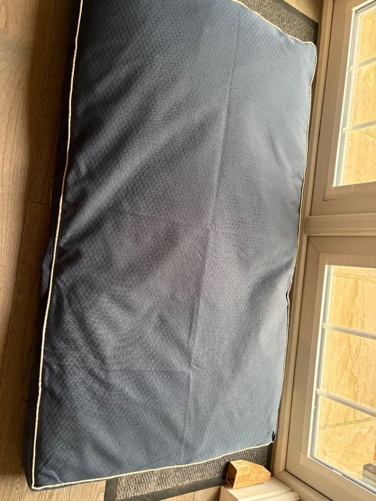 Dog bed, blanket, container plus contents.