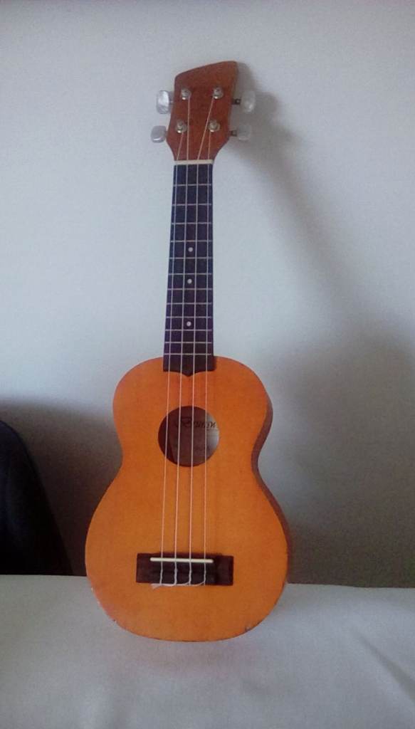 One of those tiny 4 string guitars, good condition. 