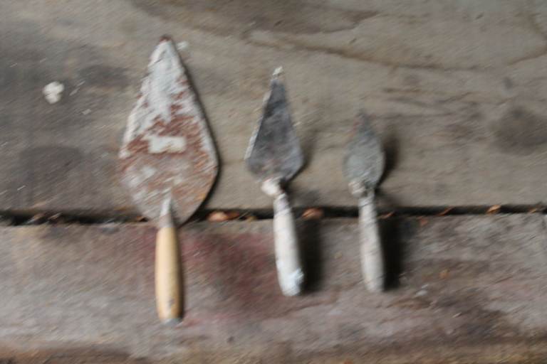 Three different sized brickie's trowels