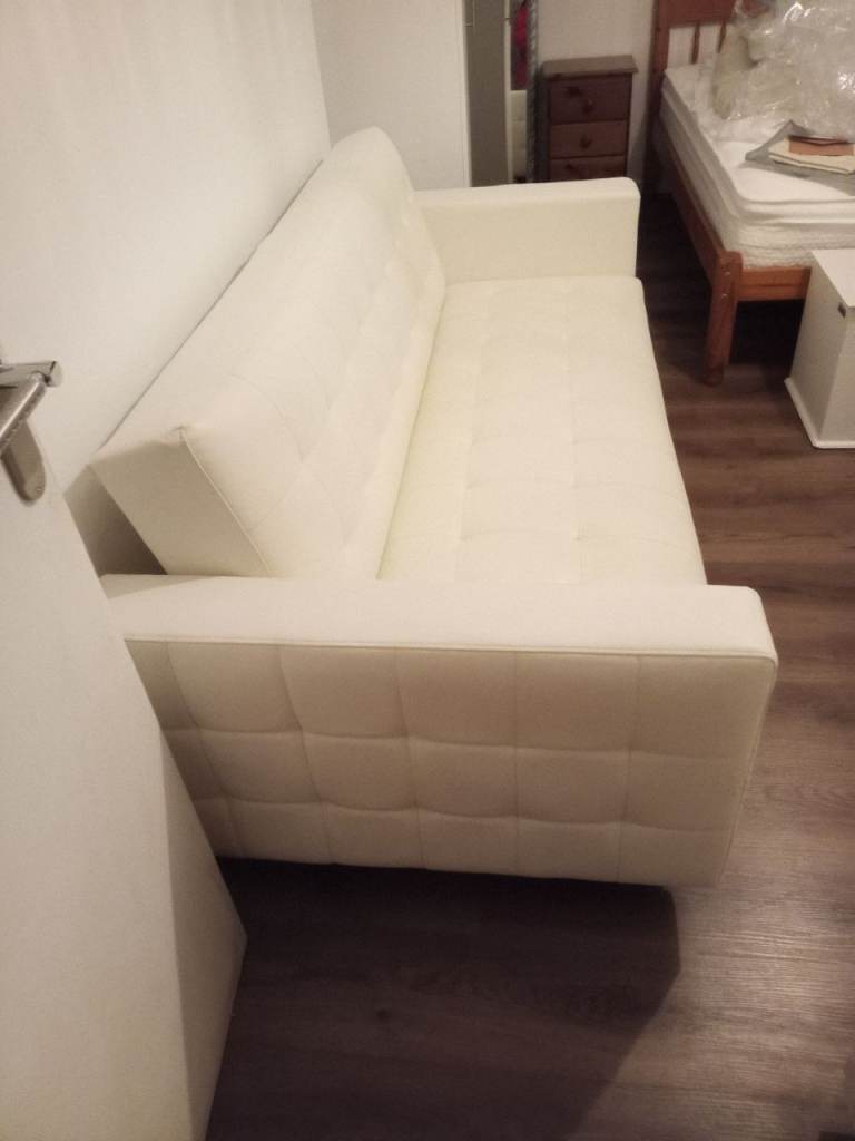 White faux leather click clack sofa bed