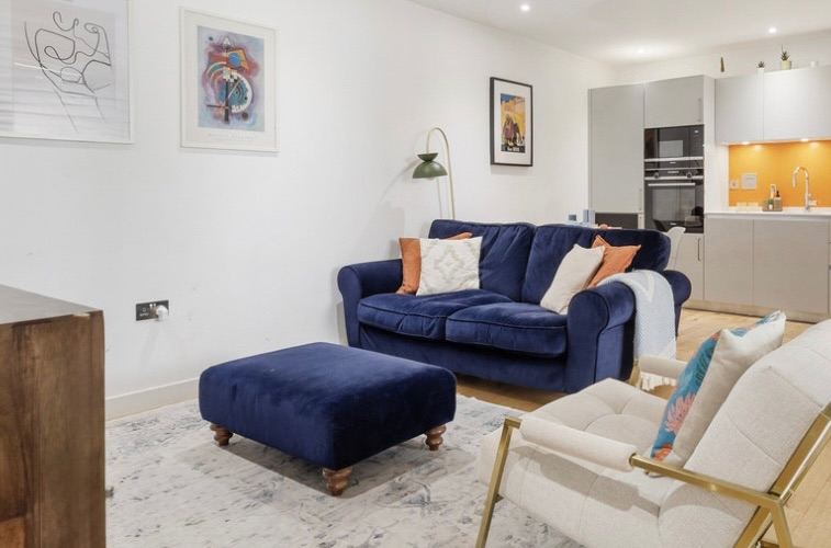 Blue Velvet Two-Seater Sofa and Matching Footstool