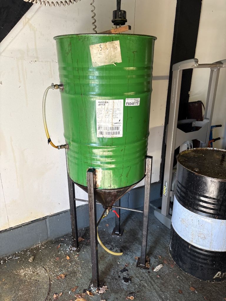 200 L oil drum with open lid and cone funnel attached to bottom, including supporting legs.
