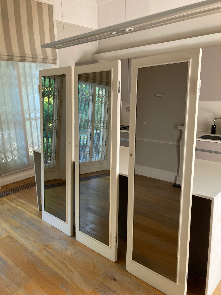 Three Large dimmed leaning mirrors