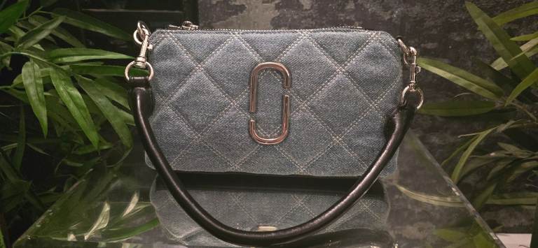Marc Jacobs The Pochette bag in light wash indigo denim. 
