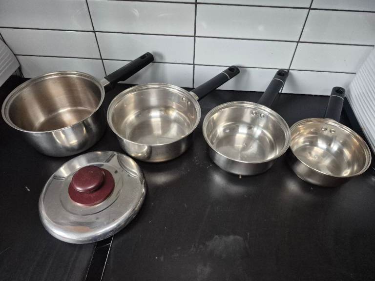 4 Stainless Steel Saucepans with Black Handles 1 lid all in good used condition 