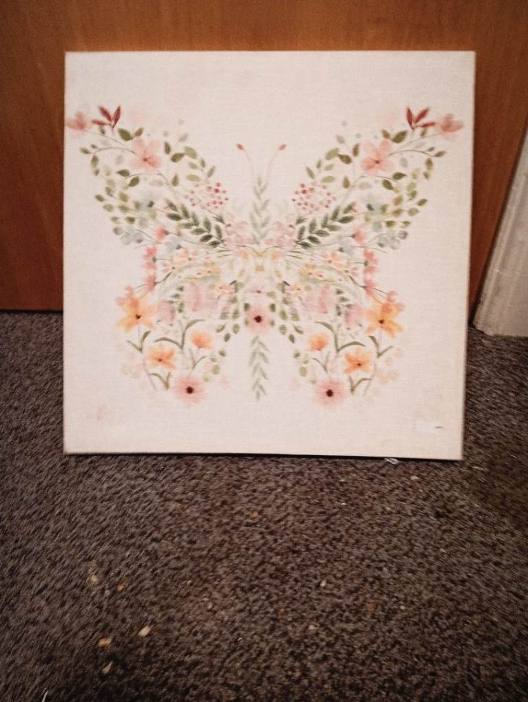 a framed canvas wall art print featuring a floral butterfly 