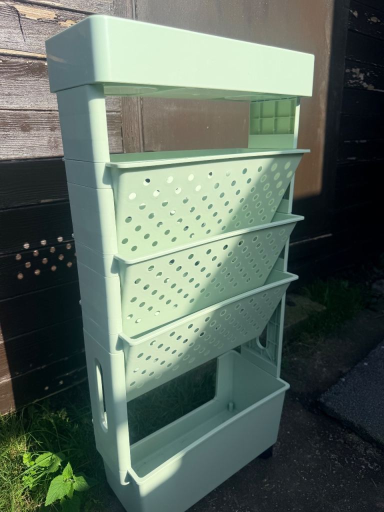 Green plastic organised with wheels 