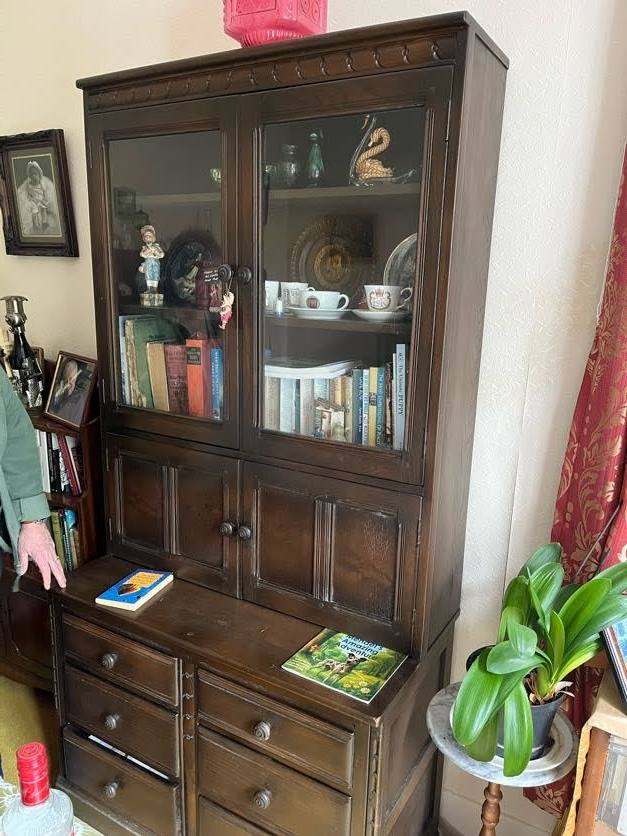  Ercol Old Colonial display cabinet featuring a dark elm wood finish