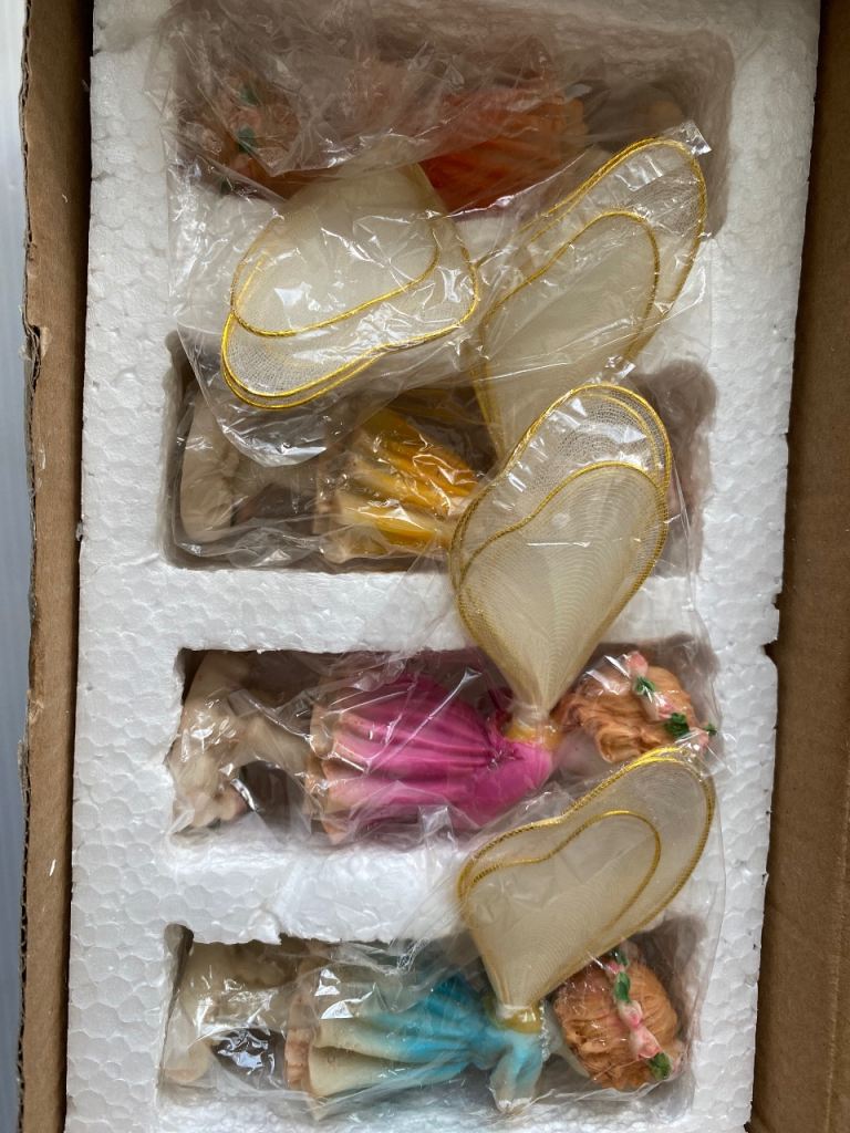 vintage-style collectibles resin fairy with holding musical instruments.