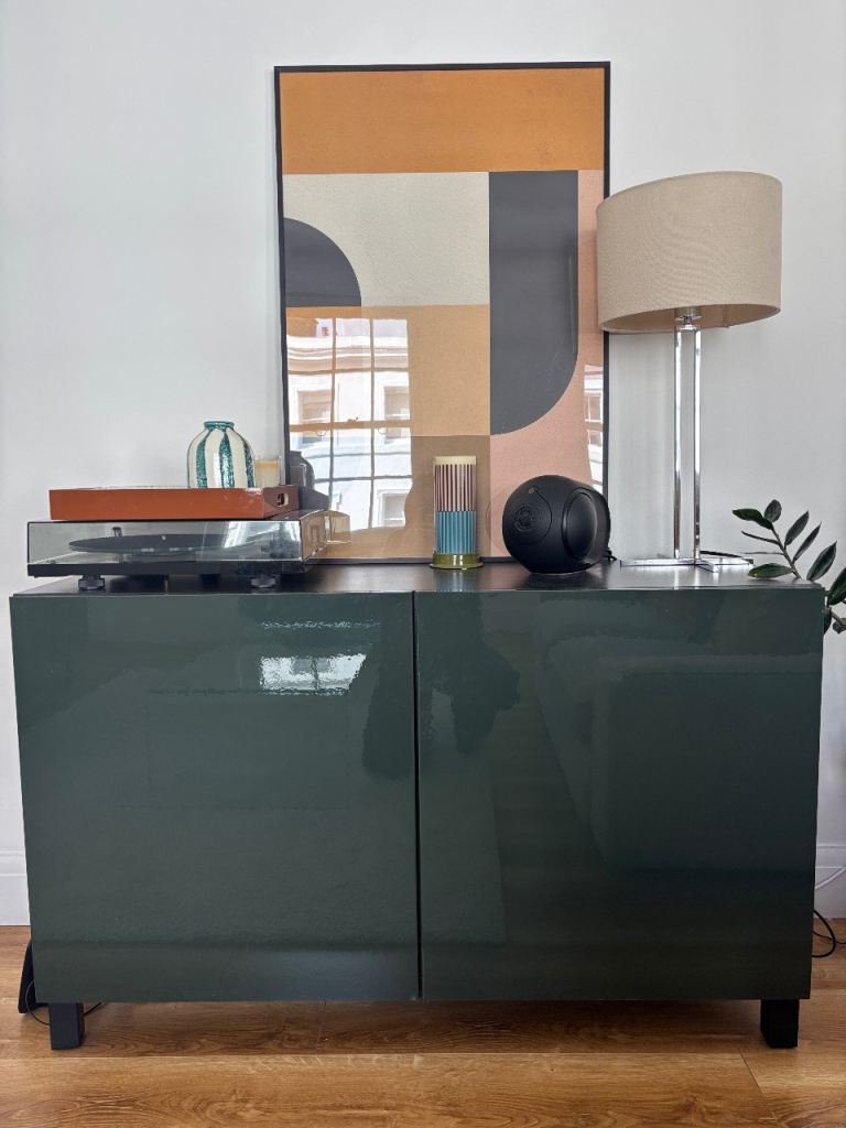 IKEA BESTA cabinet unit with doors in dark olive green and black-brown glossy finish.