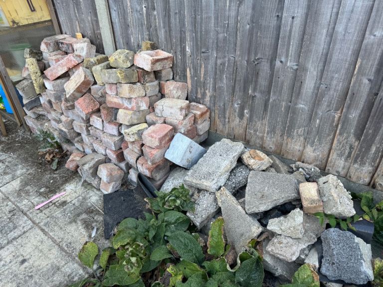 Spare bricks and assorted concrete flags