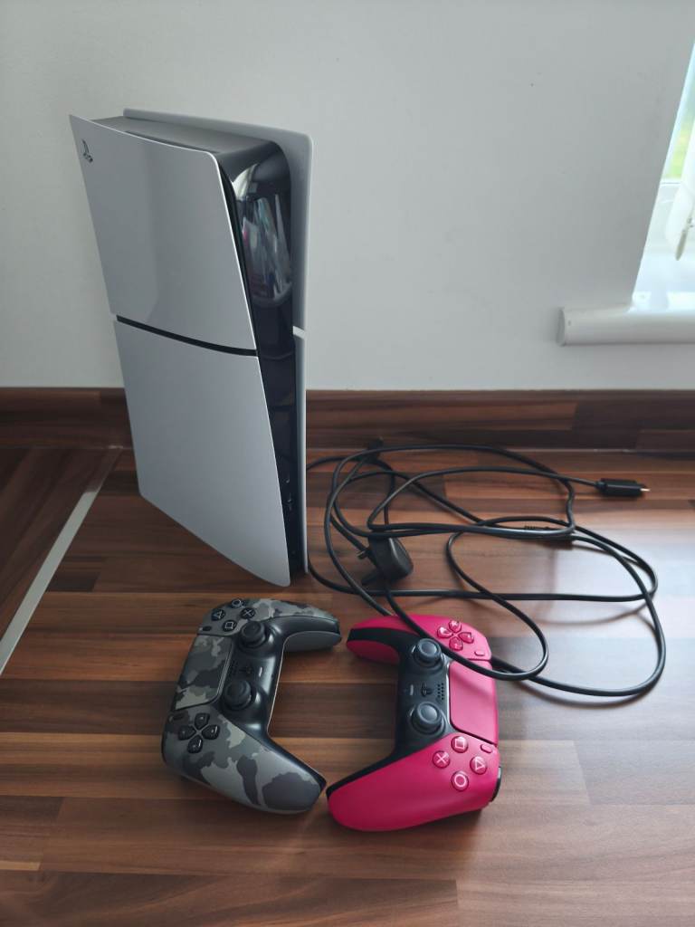 PS5 with Two Controllers and Logitech G29 Wheel Stand