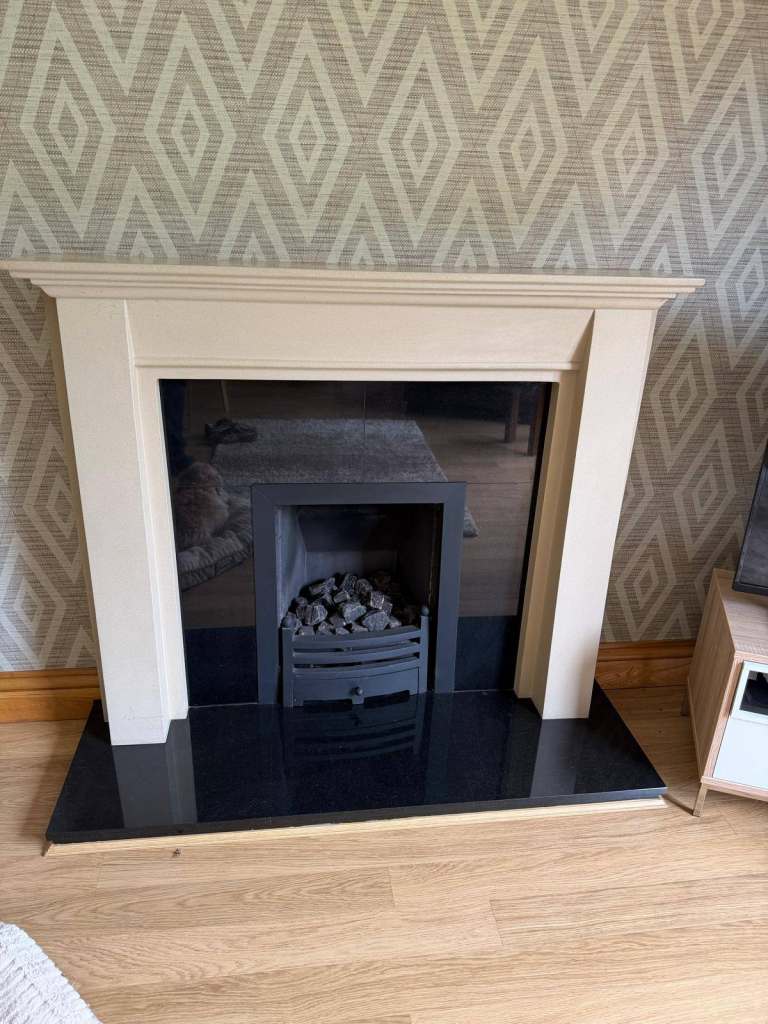 Granite fireplace and gas living flame fire.